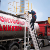 Worker using the Mobile Step Unit to gain access to the top of a tanker